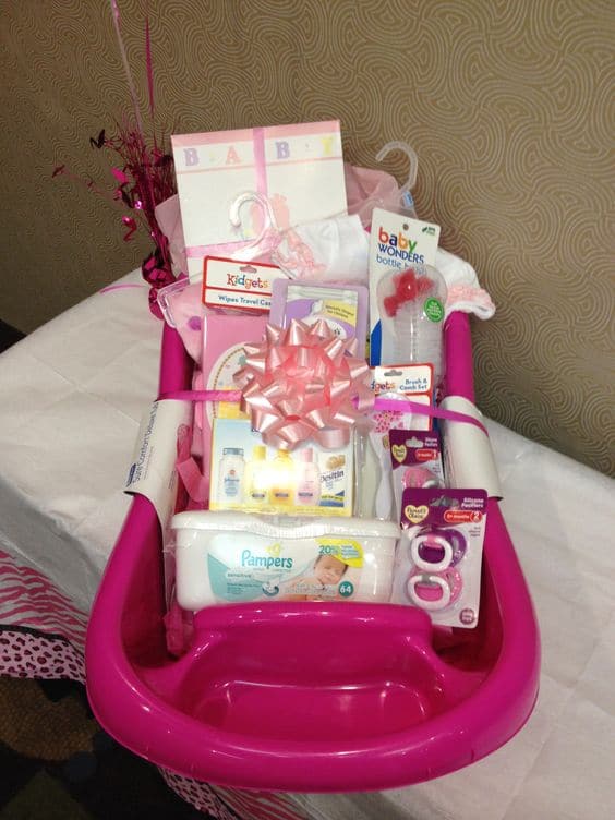 Pink baby bath full of baby shower gifts