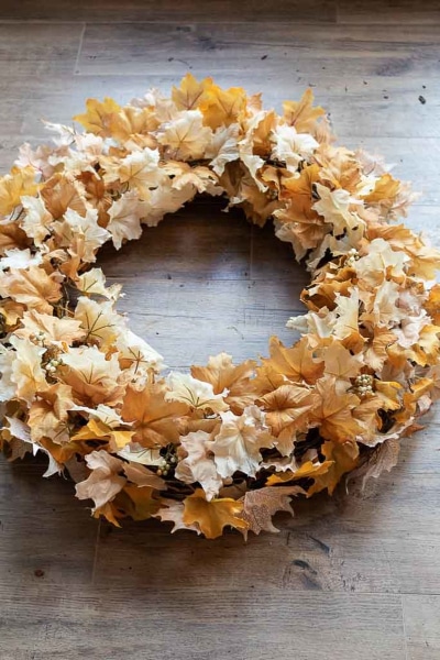 Easy Fall wreath made with grapevine wreath covered in fake fall leaves