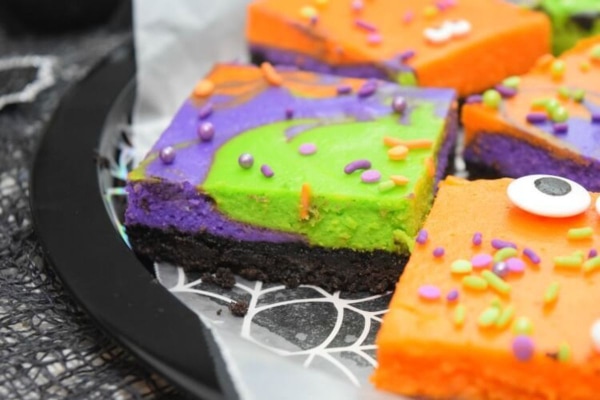 Cheesecake slice made for Halloween, green, purple, orange with googly eyes