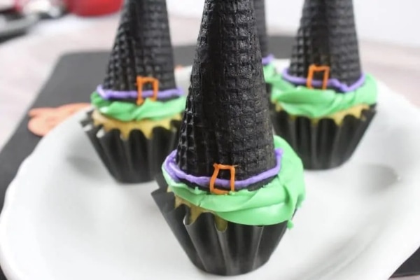 Cupcakes with black pained cone on it to look like a witches hat with green purple and orange icing