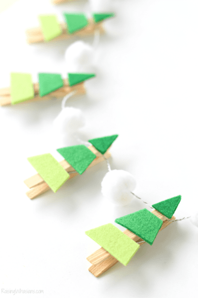 Christmas trees made from wooden clothes pegs with 3 shades of green felt and made into a garland with string and pom poms