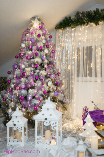 Christmas Tree with purple decorations with lights and curtains
