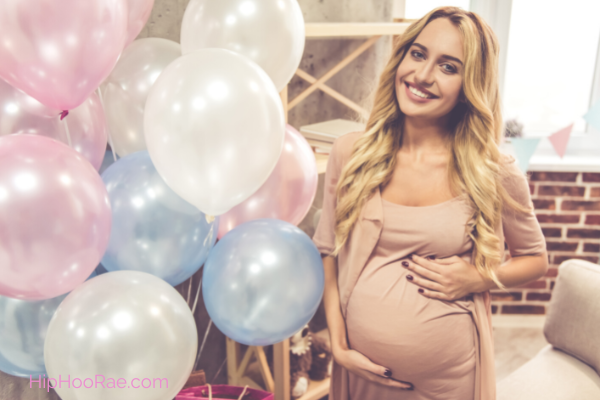 Baby Shower - Pregnant women with pink and blue balloons