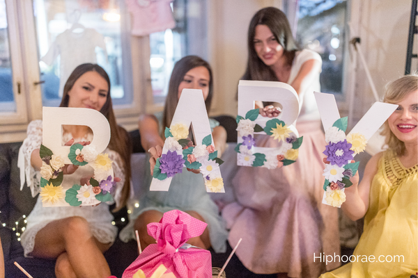 Guests holding letter BABY at Baby shower