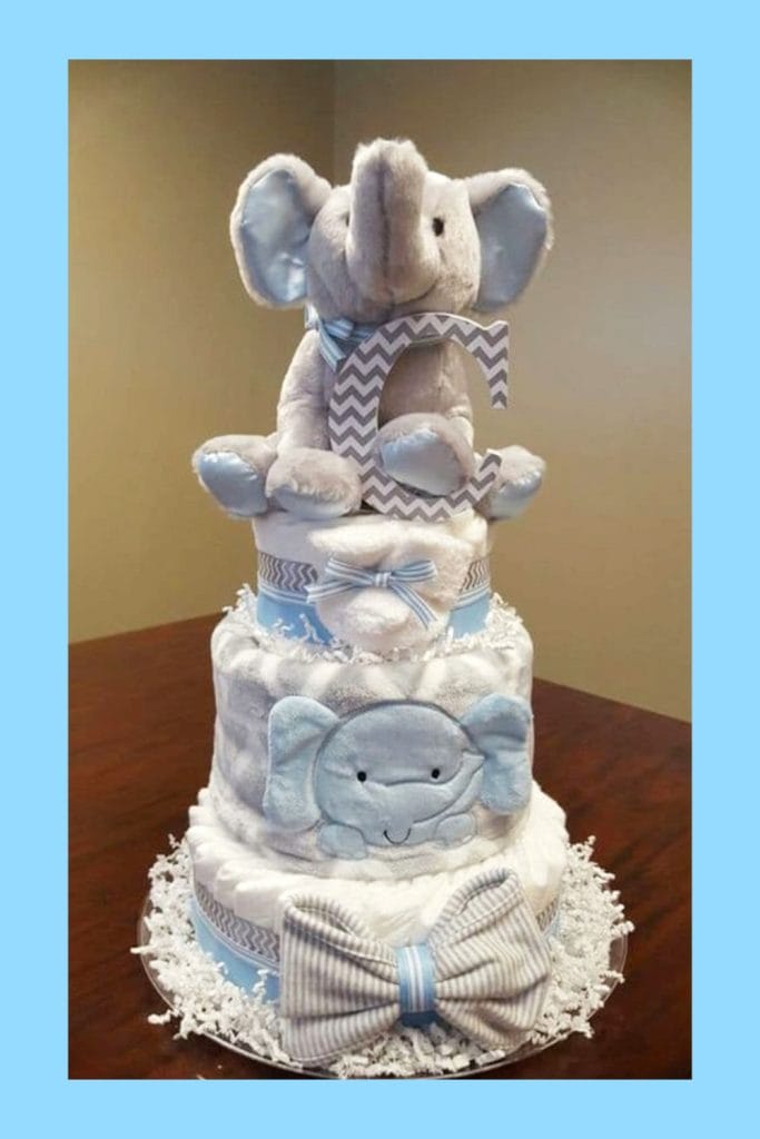 A sweet and stylish diaper cake for a little boy, this one is made with blue and white fabrics. It's easy to assemble and would make an adorable centerpiece or gift for a baby shower.