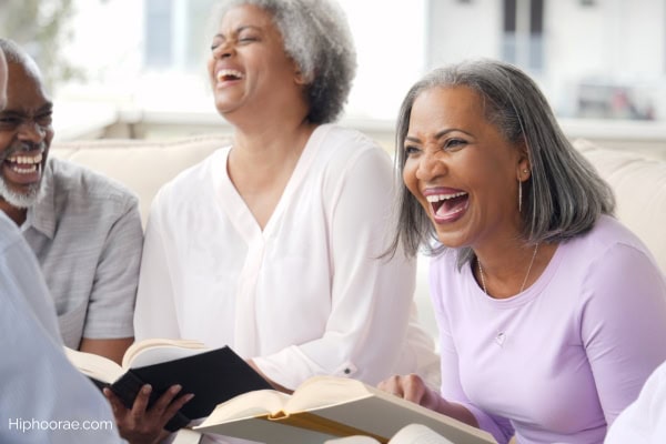 Group of seniors laughing at book club