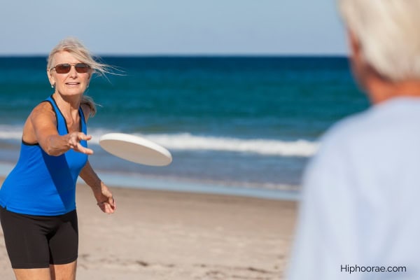 Couple playing frisbee at the beach