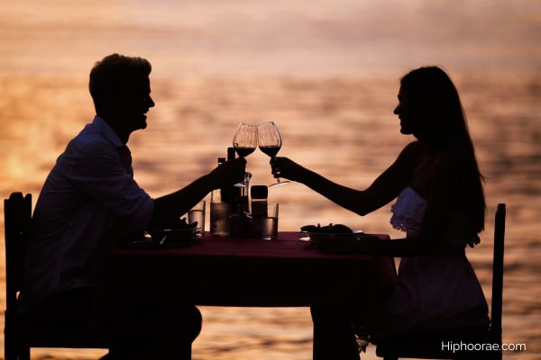 Couple having beach date during sunset