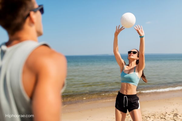 Couple playing volleyball at the beach