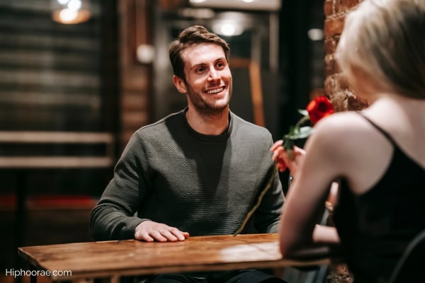 Couple on a date, woman given flowers