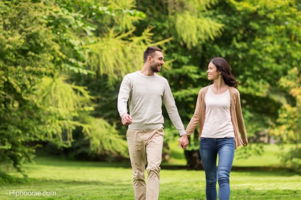 Couple holding hands walking in the park