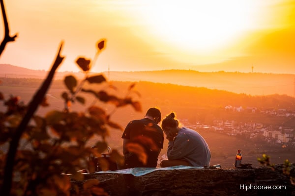 Couple having a picnic at sunset