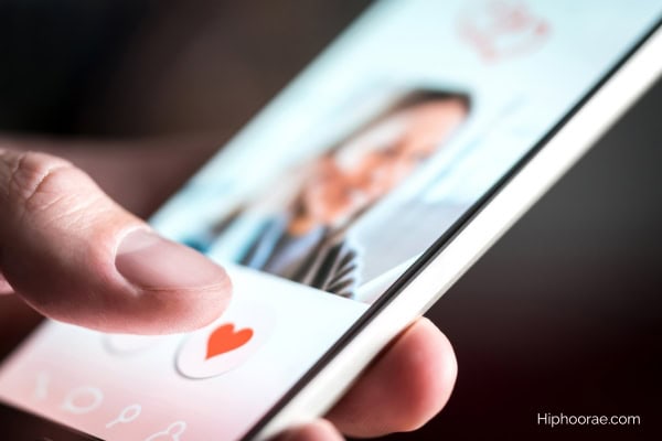 Someone's hand holding a phone using dating app