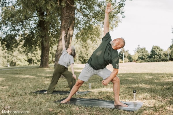 Couple doing yoga outdoors
