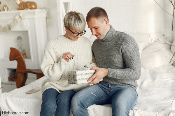 Man holding present given by girlfriend