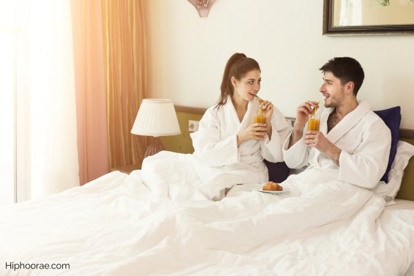 Couple having breakfast in bed