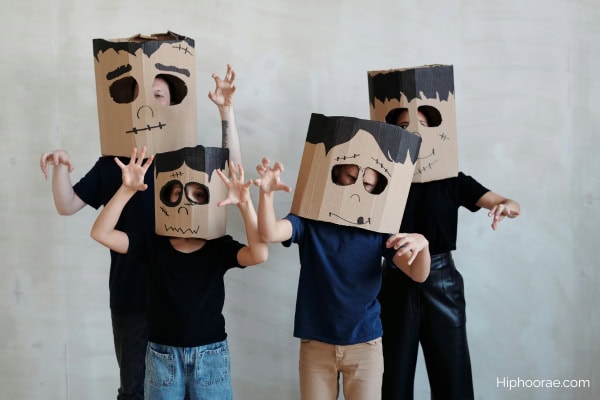family wearing DIY cardboard monster mask