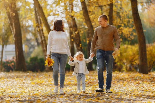 family walking in autumn park