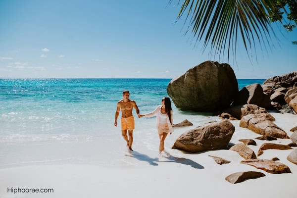 couple holding hands at the beach
