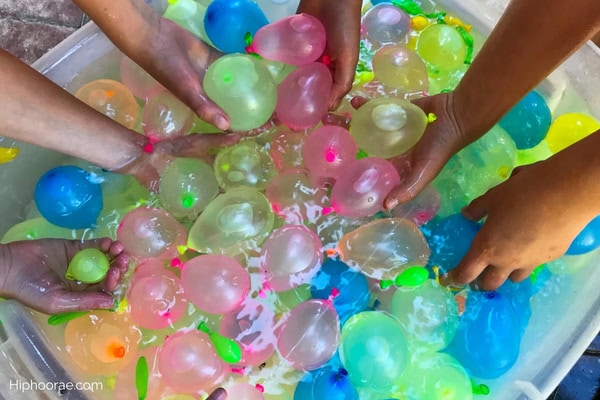 hands grabbing water balloons