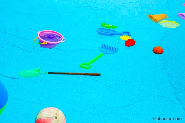 Various toys floating in swimming pool
