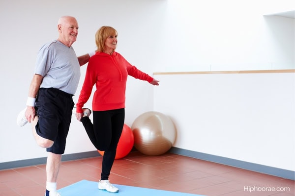senior couple balancing on one leg