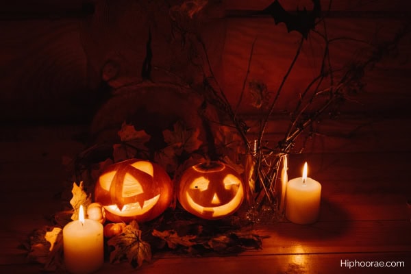 jack o lanterns and lighted candles in the dark