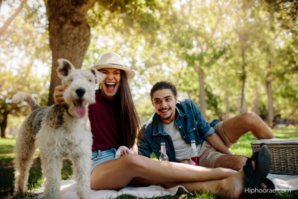couple with their dog at the park