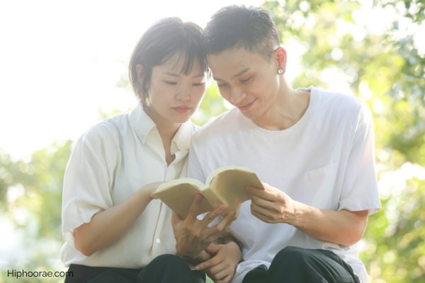 couple reading a book together outdoors