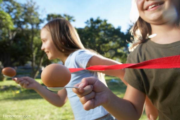 2 girls playing egg relay race