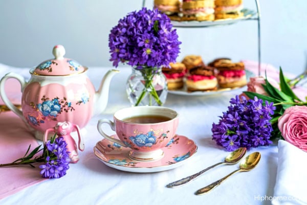 tea party table decorated with purple and pink flowers