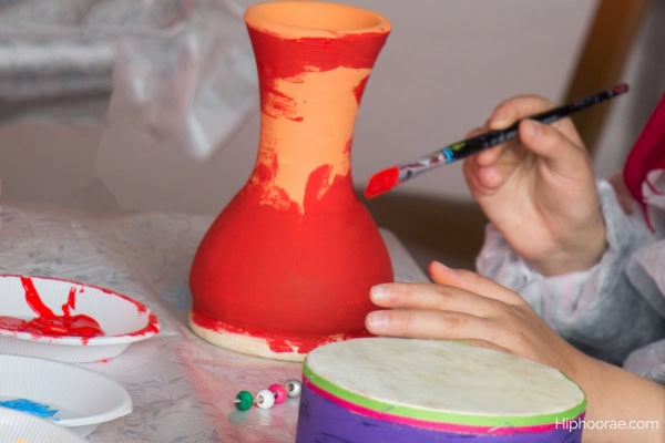 Woman painting a flower pot