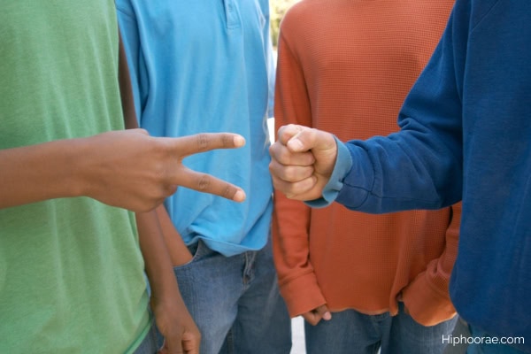 Guys playing rock paper scissors game