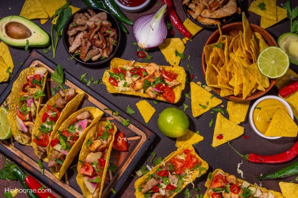 table full of tacos, nachos, and other mexican food