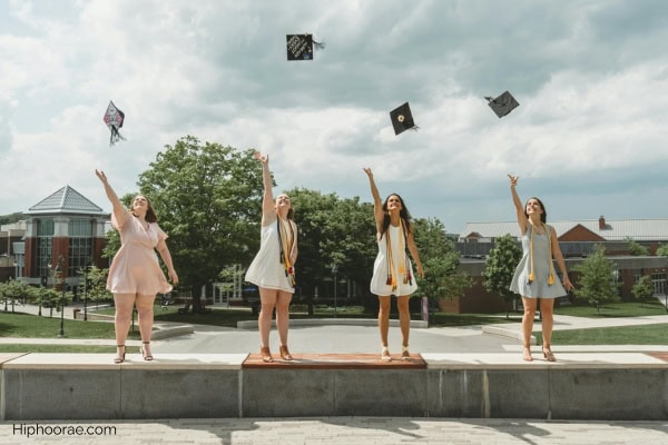graduates tossing caps in the air