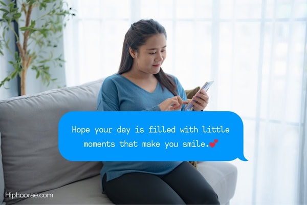 Woman smiling while looking at cellphone with quote on message bubble overlay