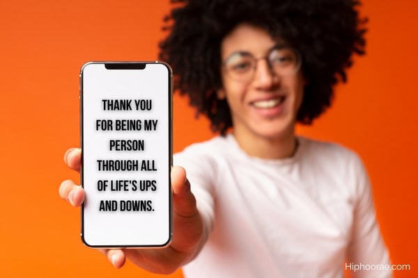 woman holding a phone up, with quote overlay on phone