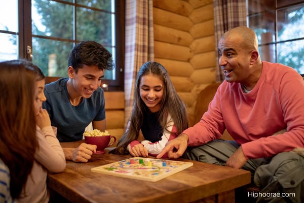 family of 5 playing a board game