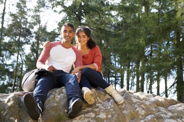 young couple hiking through countryside