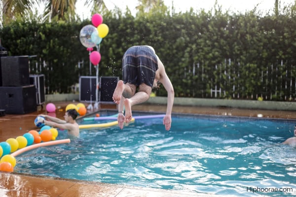 male jumping into the pool at a party