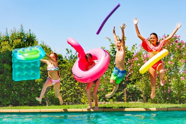 boys and girls all jumping into the pool