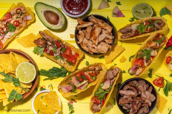 party spread of tacos, toppings, nachos, dips
