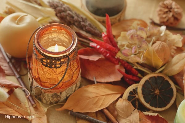 fall decorations of candle and dried botanicals