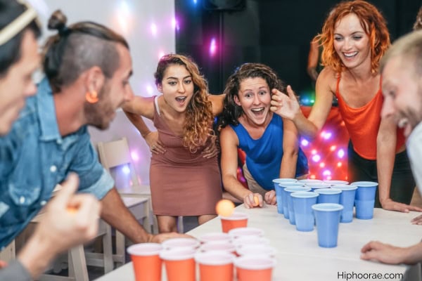 adults playing a beer game in a party