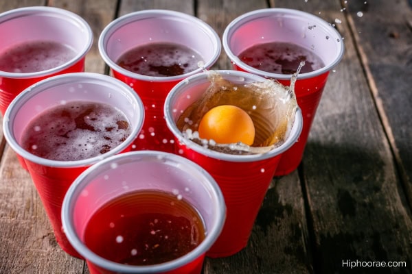 ping pong ball splashed into a cup filled with beer for a beer pong game