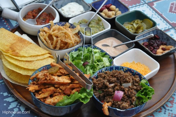 spread of taco shells, meats, vegetables, sauces, toppings for taco party